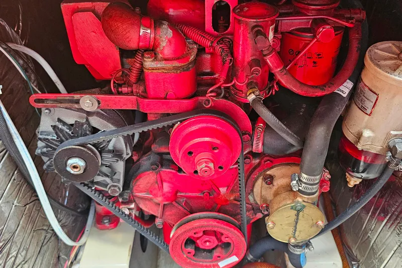 Slide: The Image of Engine of a 1987 O'Day 40 sailboat, featuring red components and belts. - 20