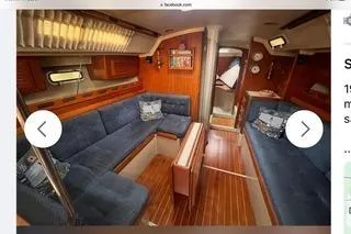 Slide: The Image of Interior of a 1987 O'Day 40 sailboat with blue seating and wooden accents. - 3