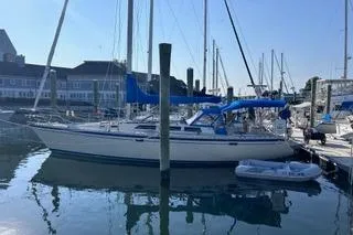 Slide: The Image of 1987 O'Day 40 sailboat docked in a marina with blue sails. - 5