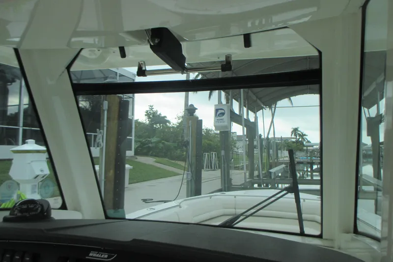 Slide: The Image of Interior view from a 2018 Boston Whaler 330 Outrage boat at a marina. - 13