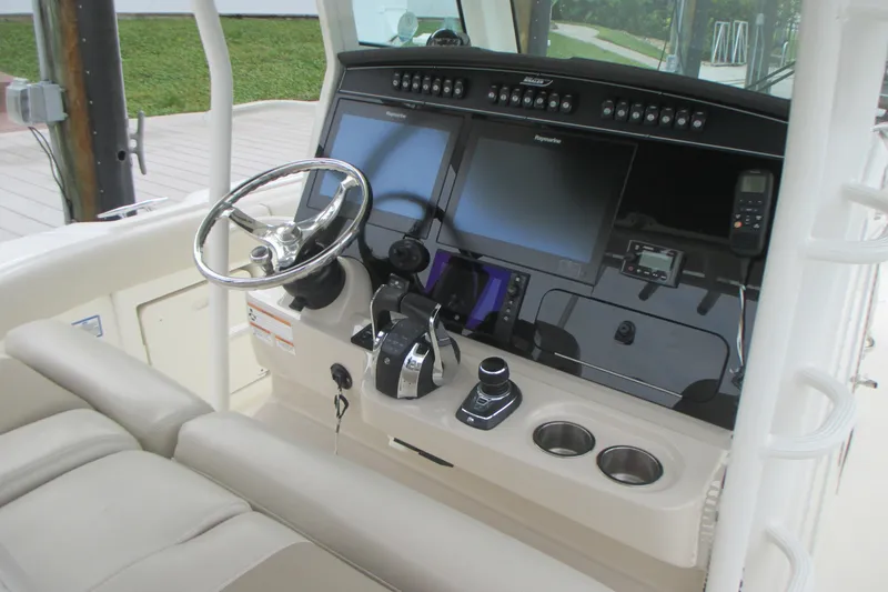 Slide: The Image of 2018 Boston Whaler 330 Outrage helm with dual screens and controls. - 16