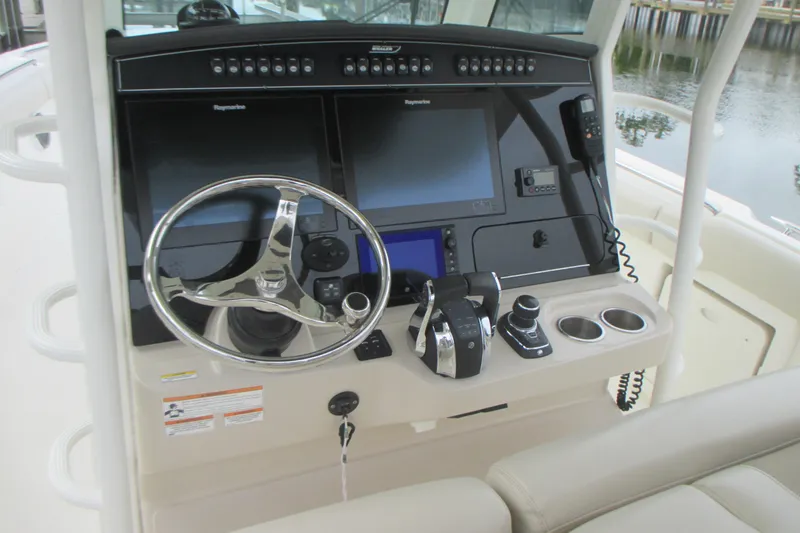 Slide: The Image of 2018 Boston Whaler 330 Outrage helm with advanced navigation controls and displays. - 17