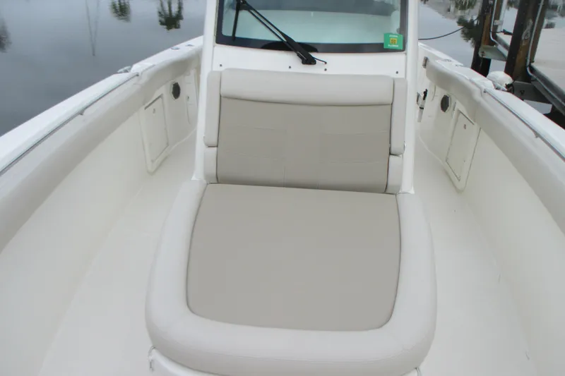 Slide: The Image of 2018 Boston Whaler 330 Outrage boat interior with cushioned seating. - 21