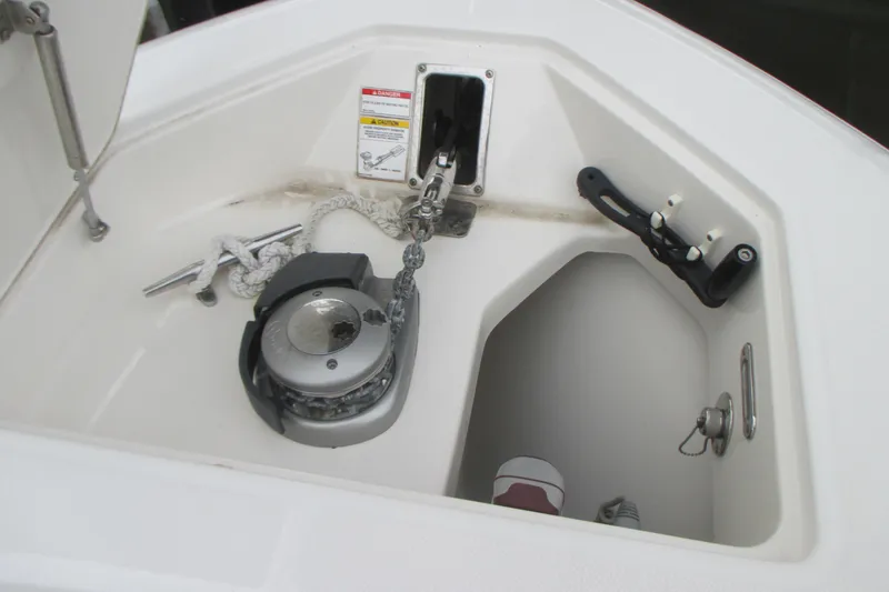 Slide: The Image of Anchor compartment of 2018 Boston Whaler 330 Outrage with winch and rope. - 26