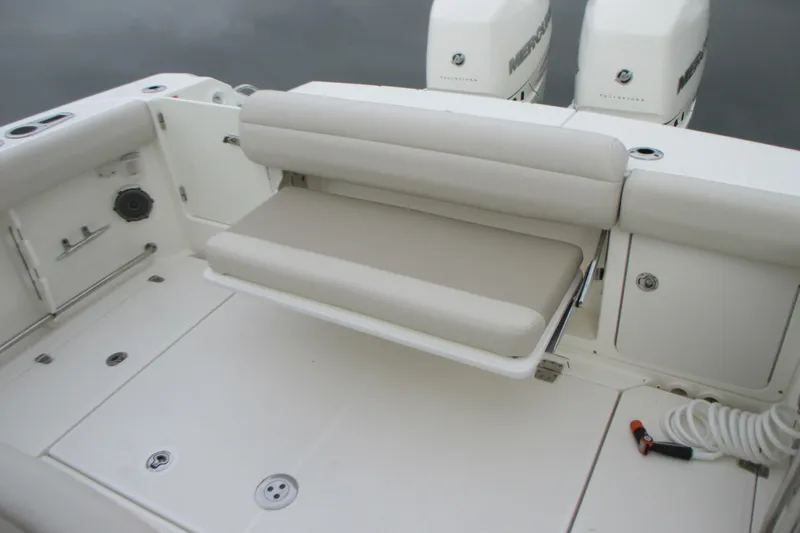 Slide: The Image of 2018 Boston Whaler 330 Outrage boat with foldable seating and dual Mercury engines. - 5