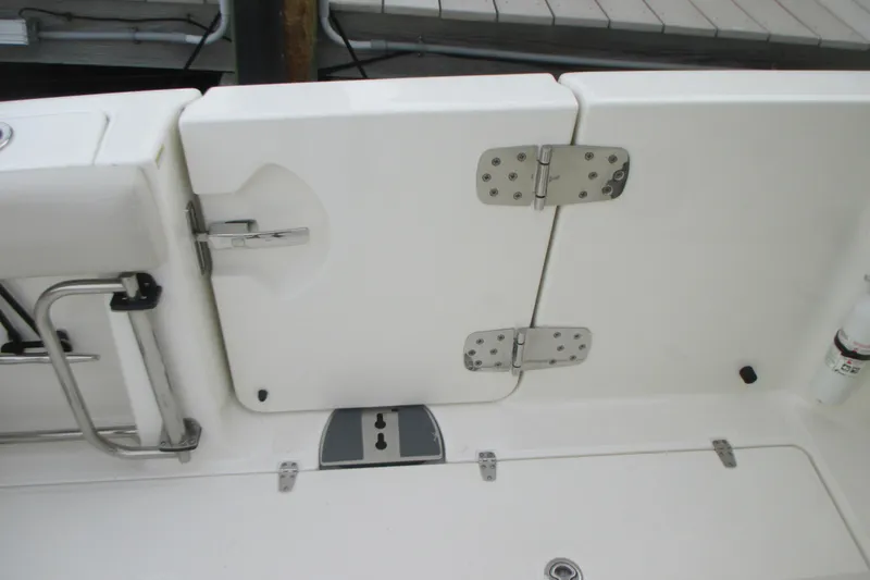 Slide: The Image of 2018 Boston Whaler 330 Outrage boat deck with stainless steel hinges and fittings. - 8