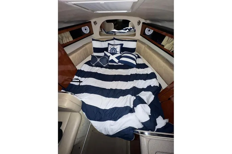 Slide: The Image of Interior cabin of 2007 Sea Ray Sundancer 280 with striped bedding. - 10