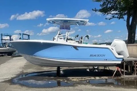 The Image of 2024 Blackfin 222 CC boat for sale, light blue hull, parked outdoors. - 0