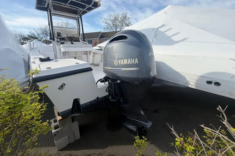 The Image of 1997 Mako 221 Center Console boat with Yamaha outboard motor, parked outdoors. - 4