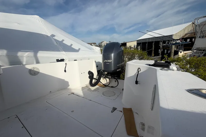 Slide: The Image of 1997 Mako 221 Center Console boat with Yamaha 200 outboard motor, docked outdoors. - 6