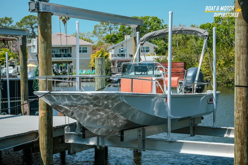 The Image of 1976 Boston Whaler 17 Montauk boat on lift at marina dock. - 0