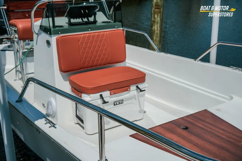 Slide: The Image of 1976 Boston Whaler 17 Montauk boat interior with red seating and Yeti cooler. - 10