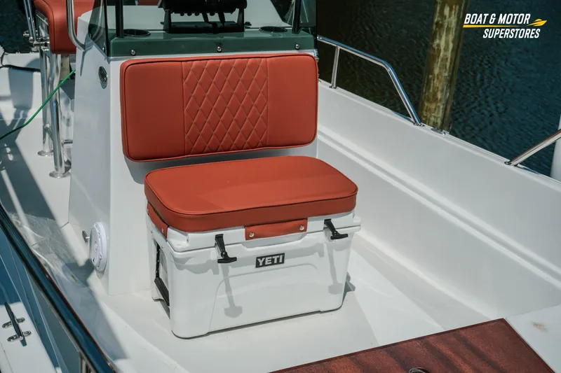 Slide: The Image of 1976 Boston Whaler 17 Montauk boat interior with Yeti cooler and cushioned seating. - 11