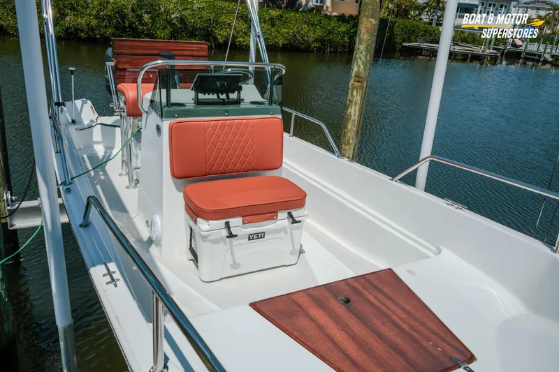 Slide: The Image of 1976 Boston Whaler 17 Montauk boat with cushioned seating and Yeti cooler on deck. - 12