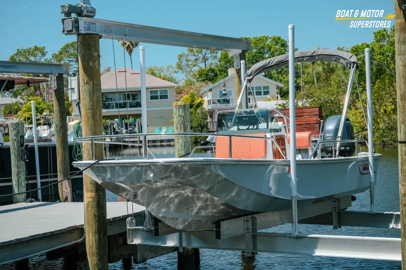 Slide: The Image of 1976 Boston Whaler 17 Montauk boat docked at marina with scenic background. - 16