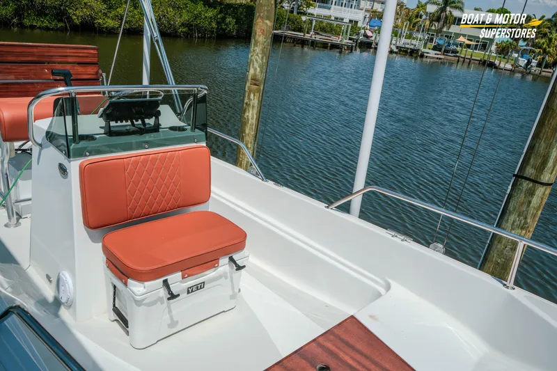Slide: The Image of 1976 Boston Whaler 17 Montauk boat interior with orange seating and Yeti cooler. - 17