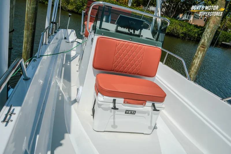 Slide: The Image of 1976 Boston Whaler 17 Montauk boat with red cushioned seating and Yeti cooler on deck. - 18