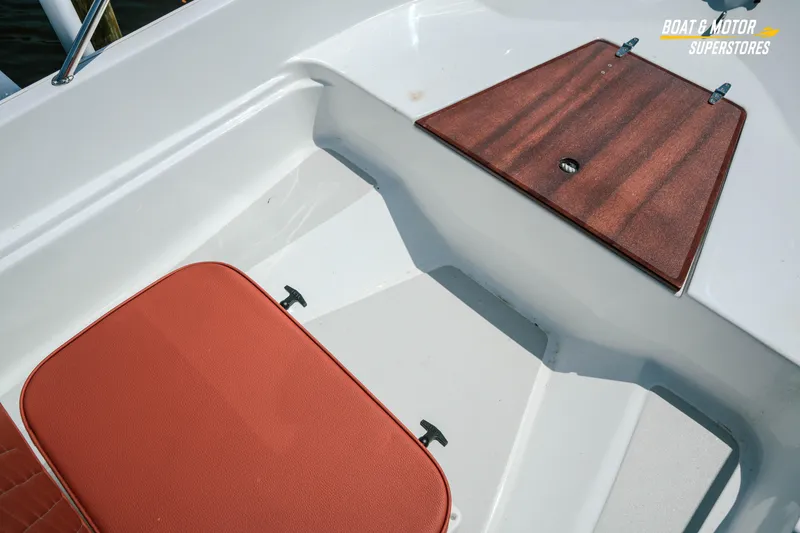 Slide: The Image of 1976 Boston Whaler 17 Montauk boat interior with red seat and wooden hatch. - 20