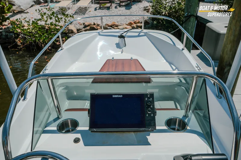 Slide: The Image of 1976 Boston Whaler 17 Montauk boat dashboard with navigation system and cup holders. - 24