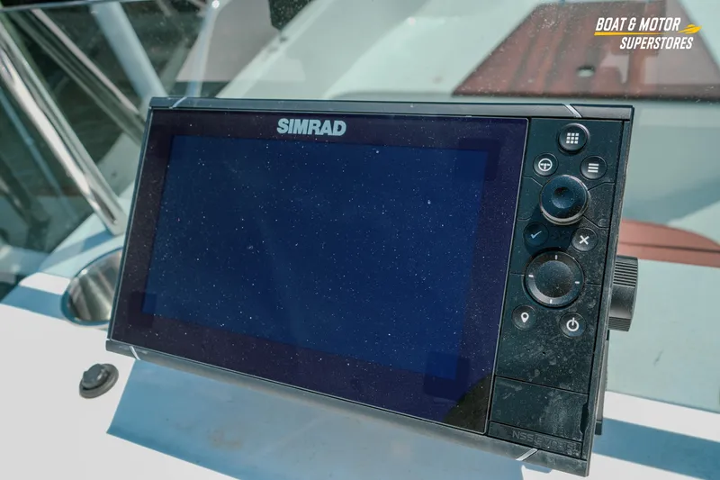 Slide: The Image of Simrad navigation system on a 1976 Boston Whaler 17 Montauk boat dashboard. - 25