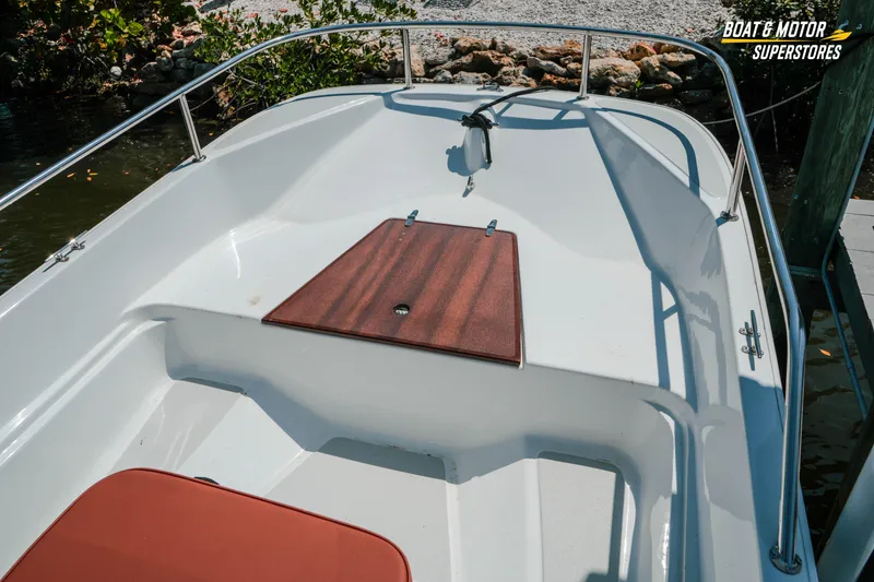 Slide: The Image of 1976 Boston Whaler 17 Montauk boat interior with wooden deck and railing. - 26