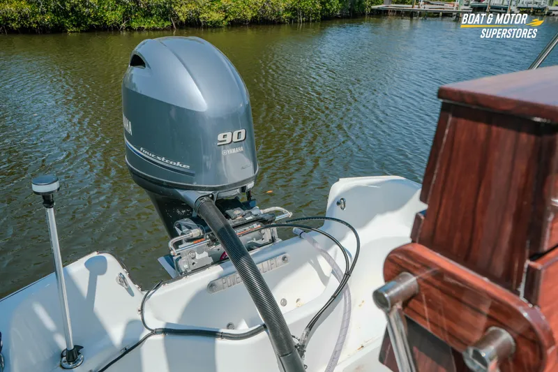 Slide: The Image of 1976 Boston Whaler 17 Montauk with Yamaha 90 outboard motor on calm water. - 28