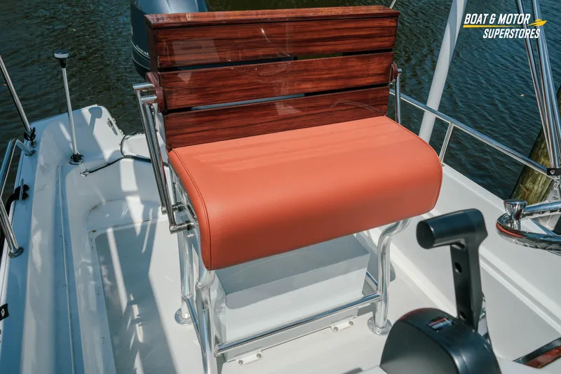 Slide: The Image of 1976 Boston Whaler 17 Montauk boat with orange seat and wooden backrest. - 29