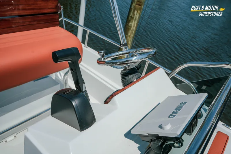 Slide: The Image of 1976 Boston Whaler 17 Montauk boat helm with steering wheel and throttle control. - 30