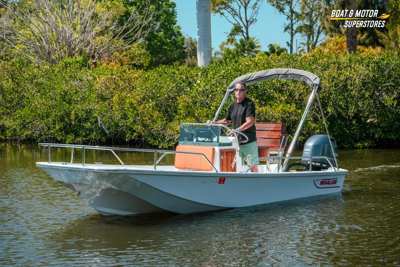 Slide: The Image of 1976 Boston Whaler 17 Montauk boat cruising on a scenic waterway. - 34