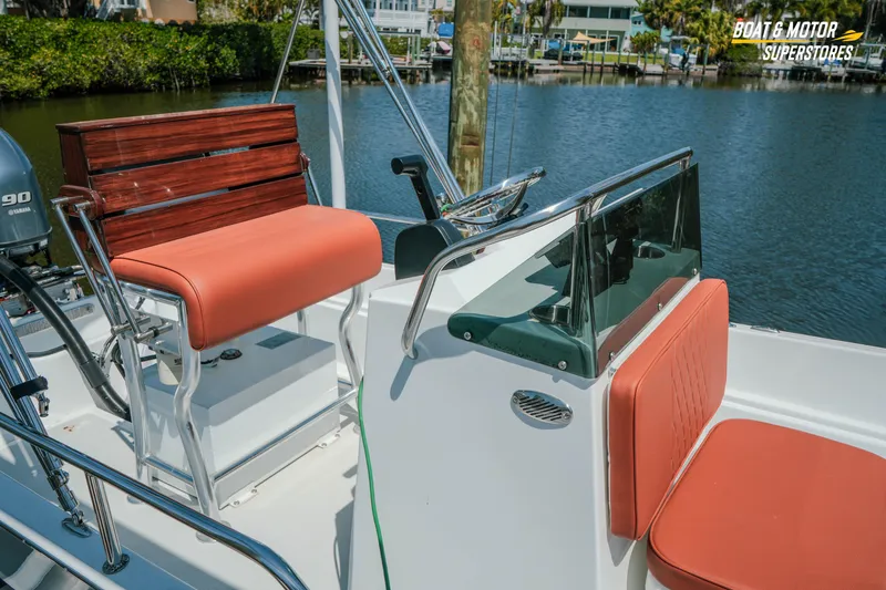Slide: The Image of 1976 Boston Whaler 17 Montauk boat interior with orange seating and Yamaha motor. - 6