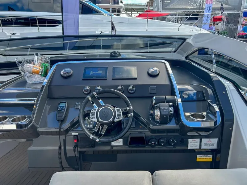 Slide: The Image of 2023 Fairline F//Line 33 Outboard helm station with modern controls and navigation screens. - 9