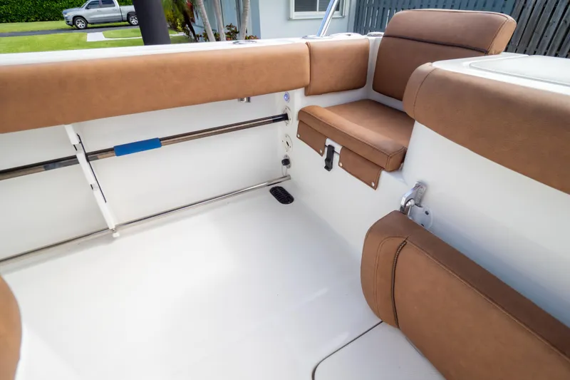 Slide: The Image of 2021 Sea Hunt Gamefish 27 Forward Seating with brown cushioned seat and measuring scale. - 103