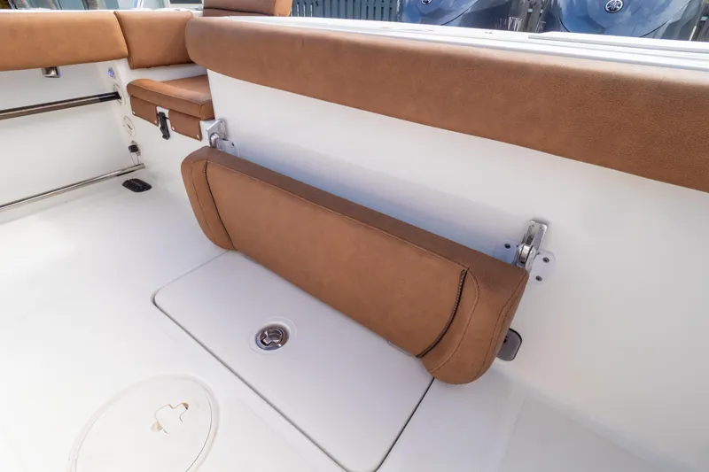 Slide: The Image of 2021 Sea Hunt Gamefish 27 boat interior with brown cushioned seating. - 104