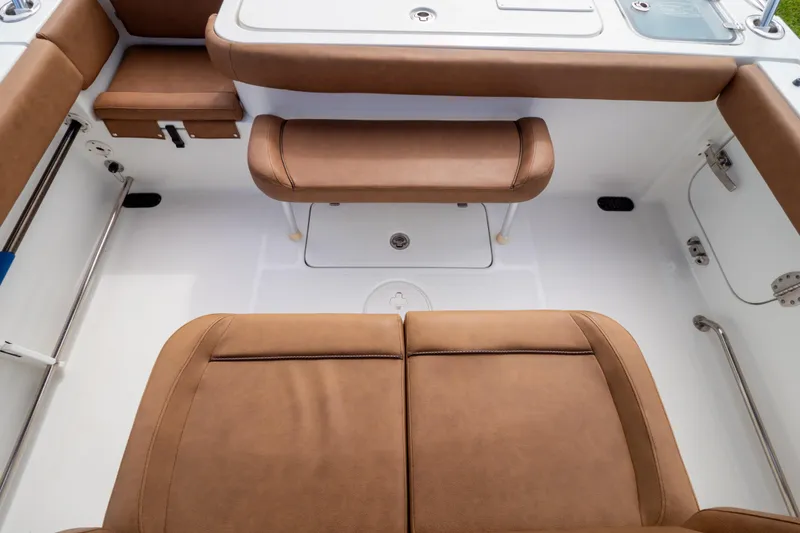 Slide: The Image of Brown cushioned seating on 2021 Sea Hunt Gamefish 27 boat, featuring forward seating design. - 106