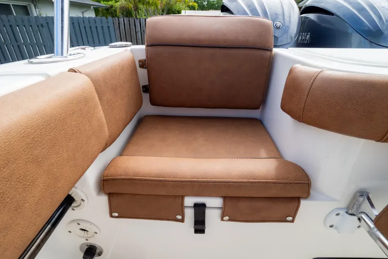 Slide: The Image of 2021 Sea Hunt Gamefish 27 Forward Seating storage compartment with open lid and cushioned seats. - 108