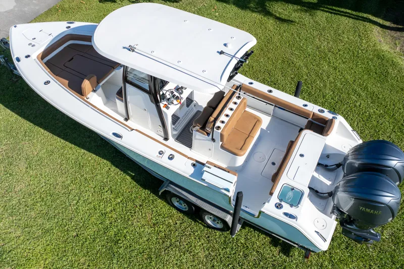 Slide: The Image of 2021 Sea Hunt Gamefish 27 boat with forward seating, dual Yamaha engines, and spacious deck. - 11