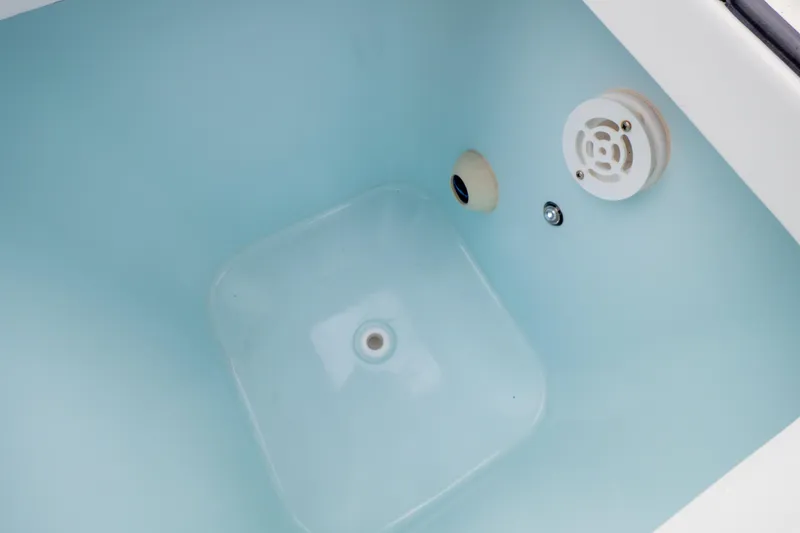 Slide: The Image of 2021 Sea Hunt Gamefish 27 boat engine compartment with hose and motor flush system. - 114