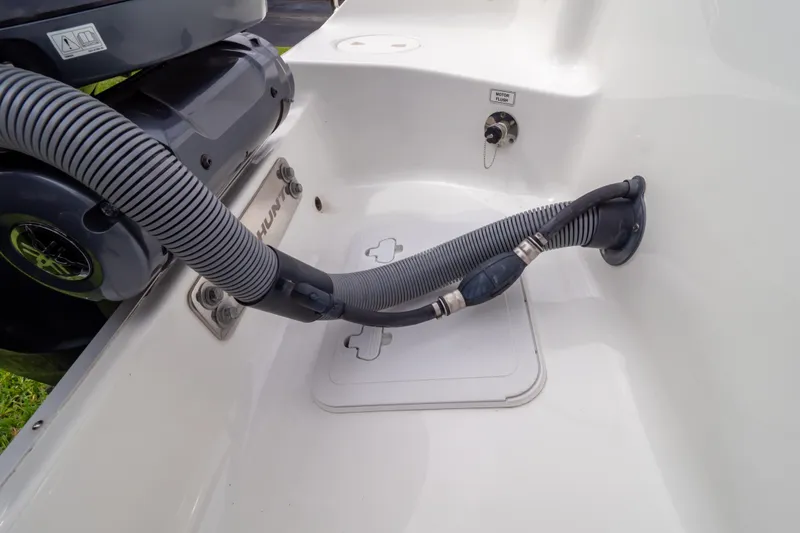 Slide: The Image of 2021 Sea Hunt Gamefish 27 boat covered, parked on a trailer in a grassy area. - 116