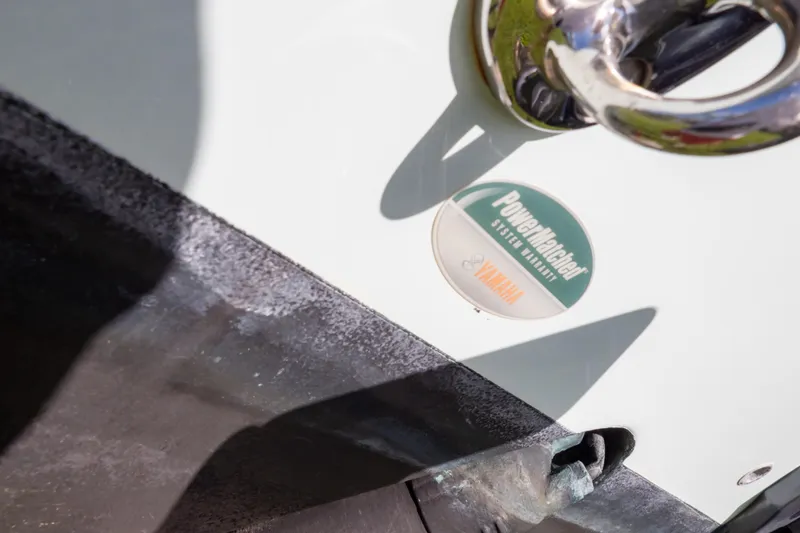 Slide: The Image of Boat trailer with Sea Hunt Gamefish 27, 2021 model, parked on grass near a house. - 124