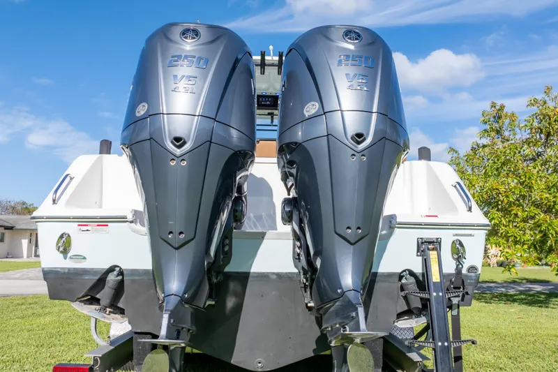 Slide: The Image of 2021 Sea Hunt Gamefish 27 boat with twin Yamaha engines on a trailer. - 19