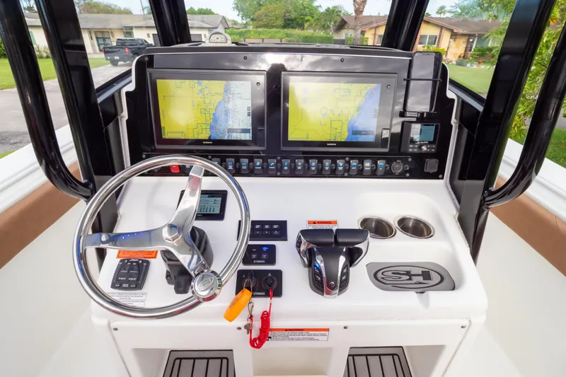 Slide: The Image of Steering wheel and controls of 2021 Sea Hunt Gamefish 27 Forward Seating boat. - 22