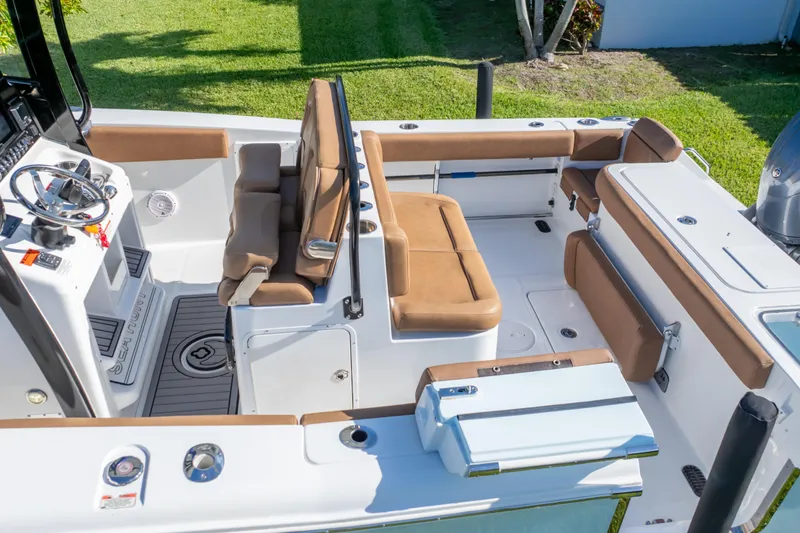 Slide: The Image of 2021 Sea Hunt Gamefish 27 boat interior with tan seating and modern console. - 3
