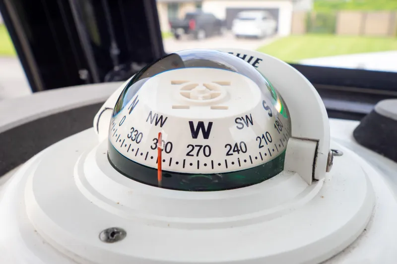 Slide: The Image of 2021 Sea Hunt Gamefish 27 control panel with warning labels and trim tab controls. - 30