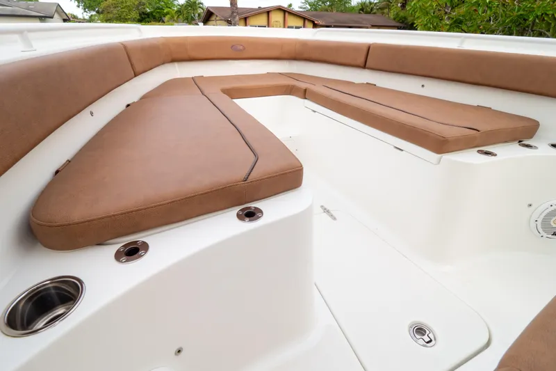 Slide: The Image of 2021 Sea Hunt Gamefish 27 boat on trailer, parked on grass, surrounded by trees. - 43