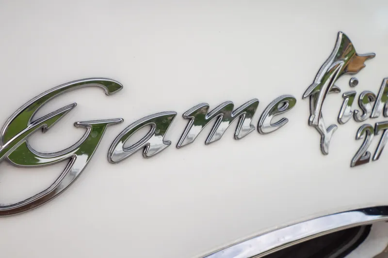 Slide: The Image of Sea Hunt Gamefish 27 Forward Seating 2021 model emblem in sleek chrome finish. - 47