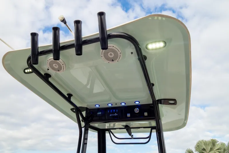 Slide: The Image of 2021 Sea Hunt Gamefish 27 T-top with rod holders and LED lights against cloudy sky. - 49