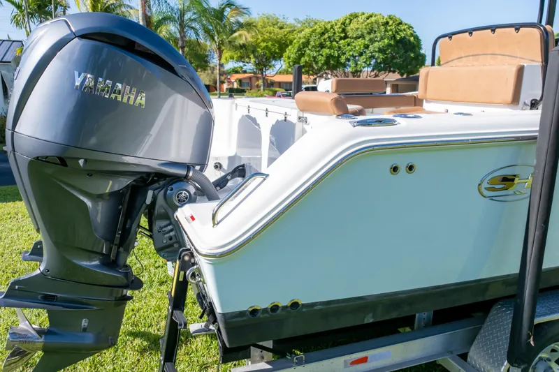 Slide: The Image of 2021 Sea Hunt Gamefish 27 with Yamaha outboard engine, parked on a trailer. - 5