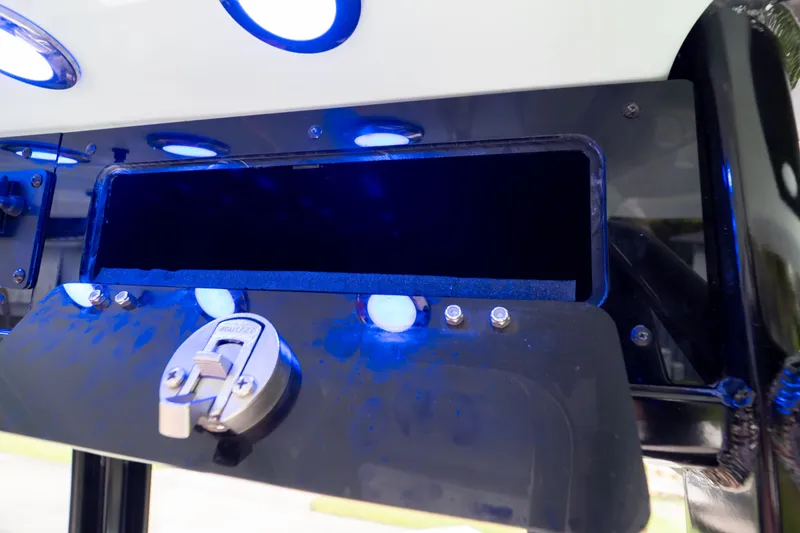 Slide: The Image of 2021 Sea Hunt Gamefish 27 storage compartment with blue LED lighting. - 51