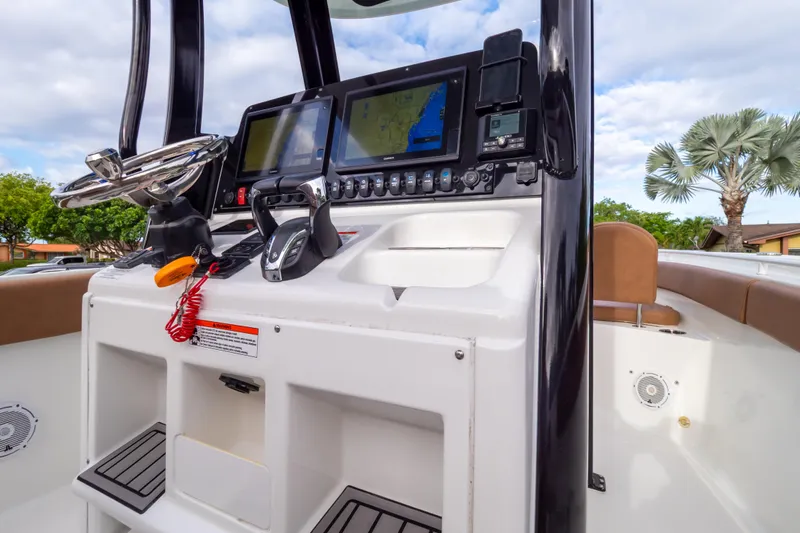 Slide: The Image of Control panel of 2021 Sea Hunt Gamefish 27 boat with navigation screens and steering wheel. - 54