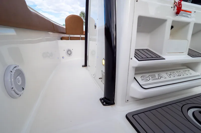 Slide: The Image of 2021 Sea Hunt Gamefish 27 boat interior with compact marine toilet and waste disposal notice. - 72